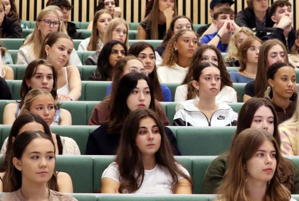 Students sit in rows in a lecture theatre