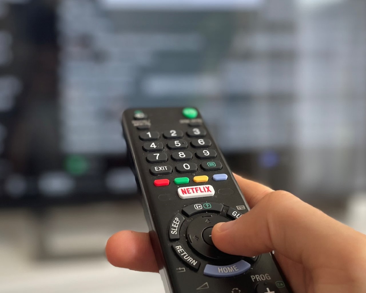 Remote control pointed at a television