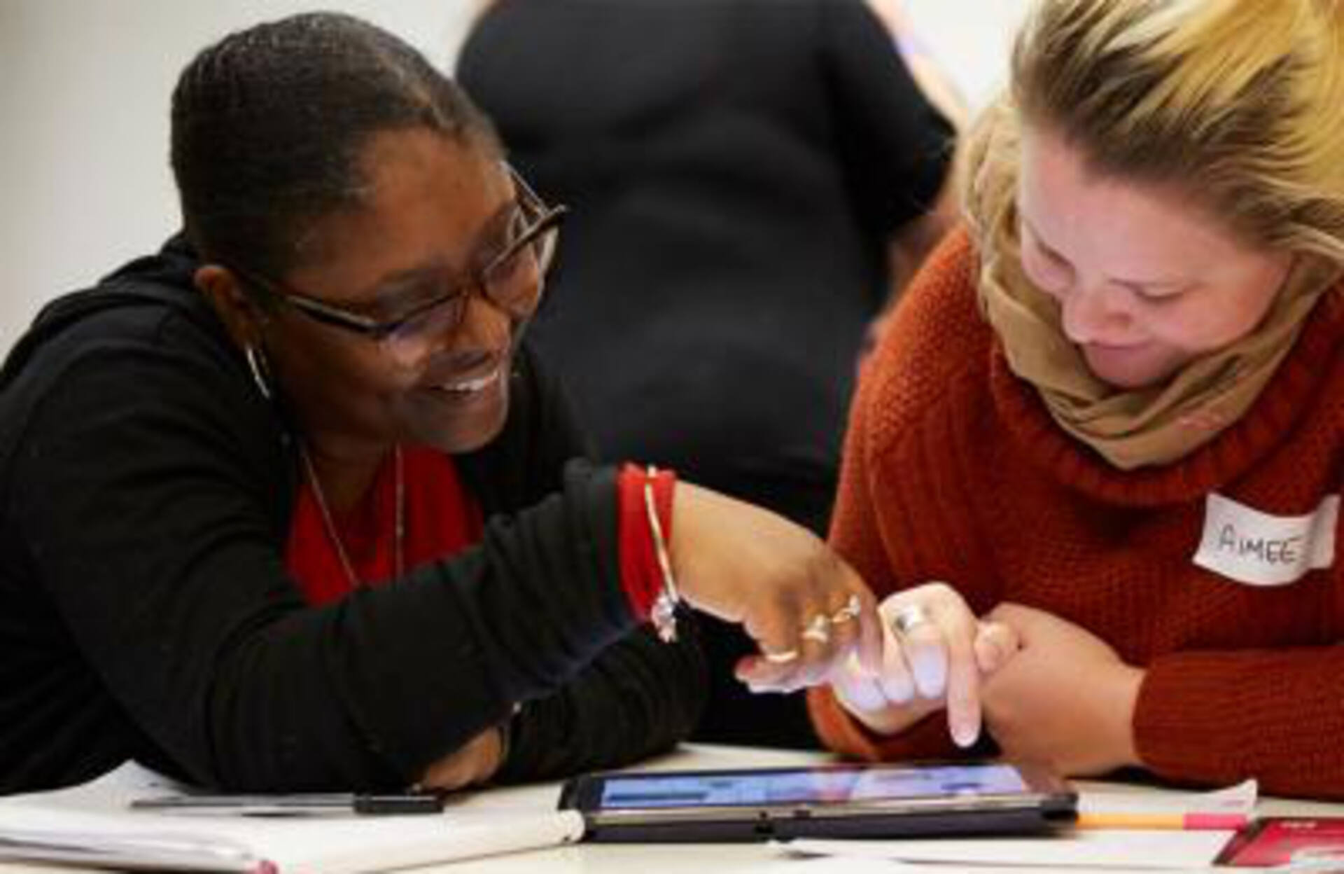 Two people using a tablet