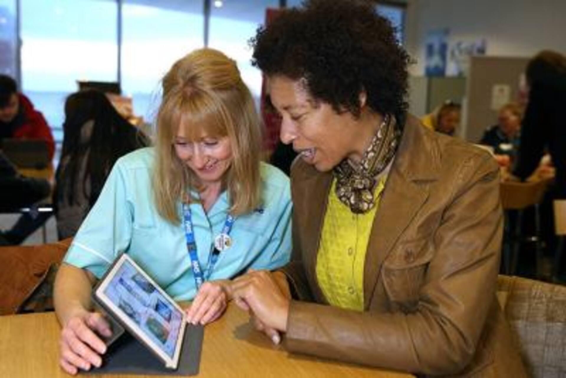 Two people using a tablet