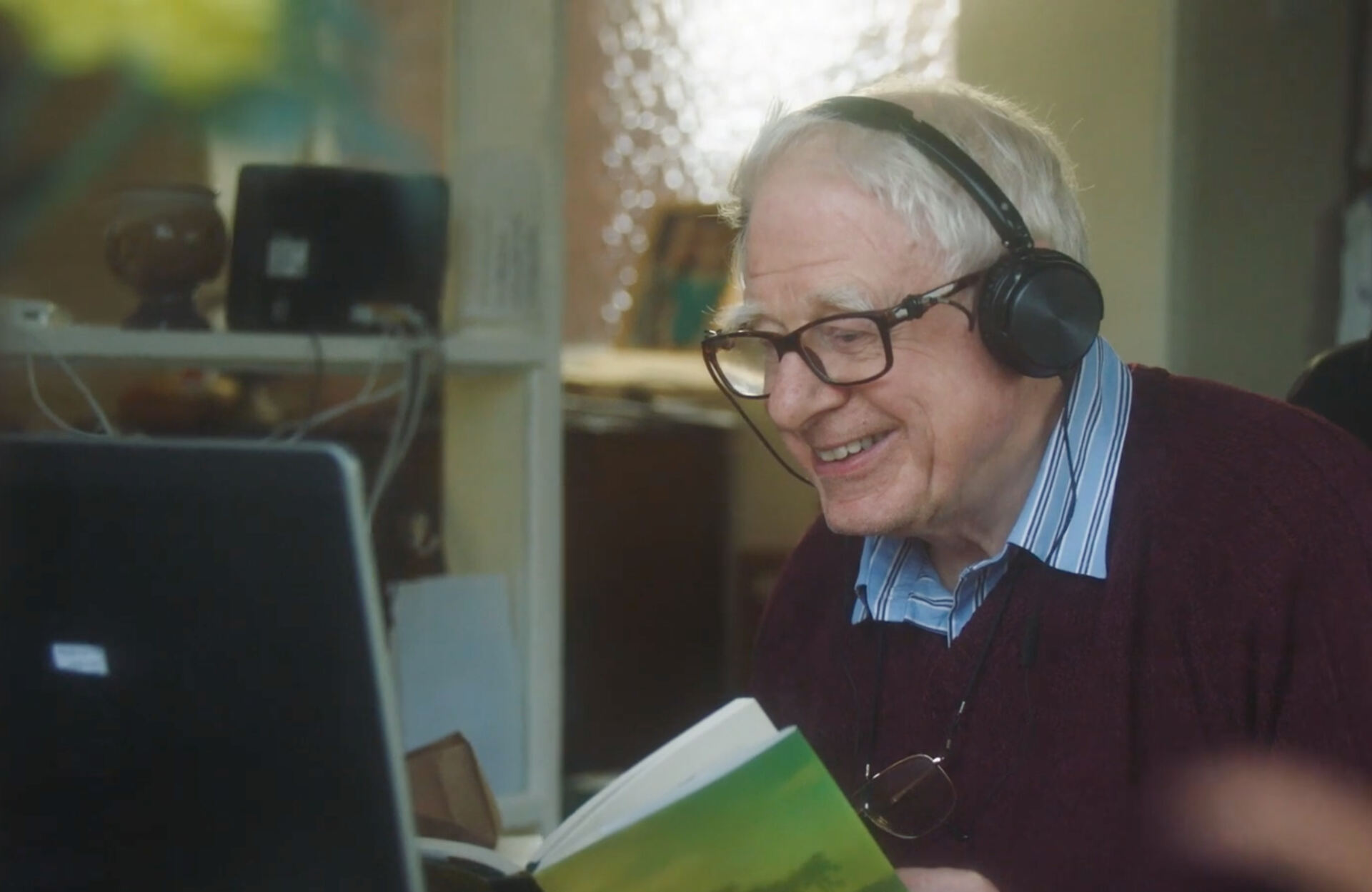 Man reading book with headphones