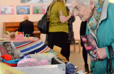 Older person looking at box full of things