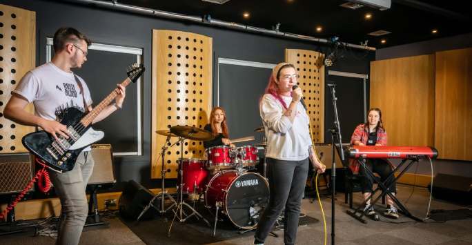 Students on stage playing instruments