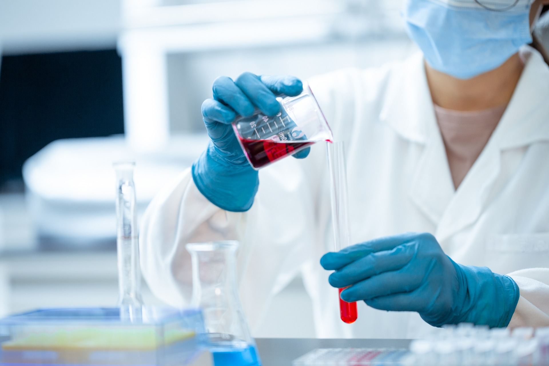 Scientist pouring liquid into a test tube