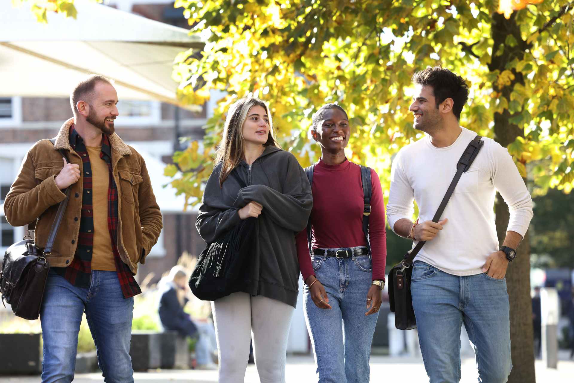 Postgraduate students walking across University of Liverpool campus