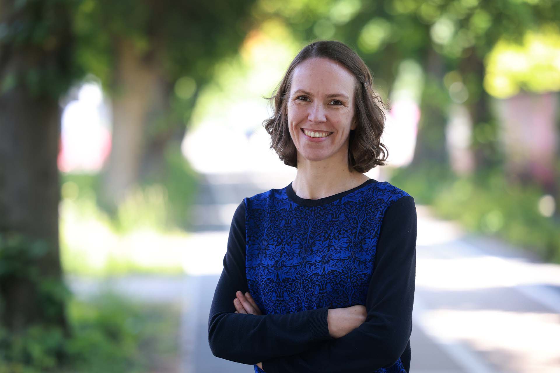 Professor Heazlewood standing near trees on campus