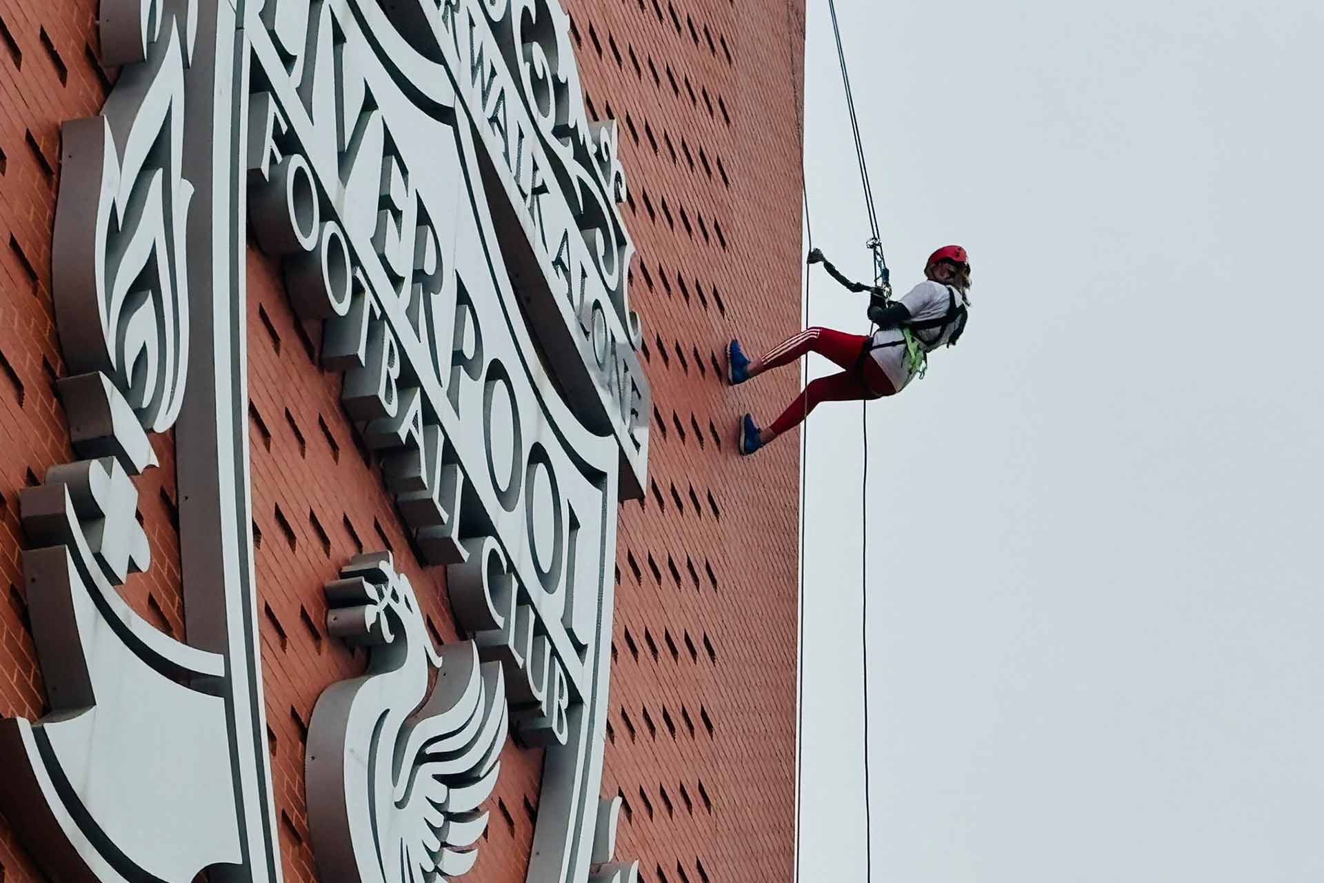 Vicki Reynolds abseiling down the main stand at Anfield