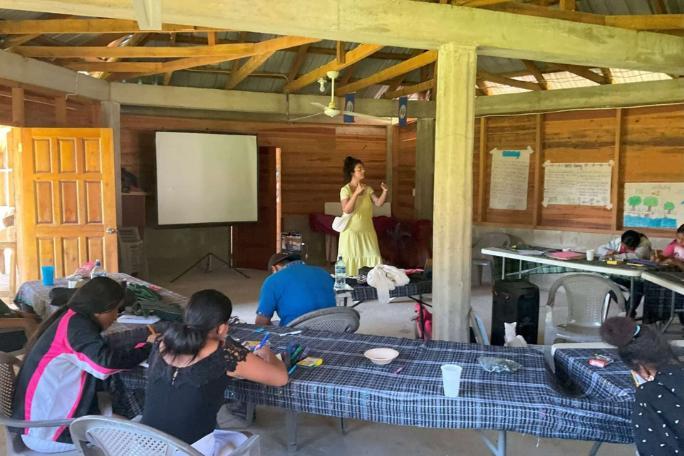 Cara giving a talk to members of a Maya community in southern Belize