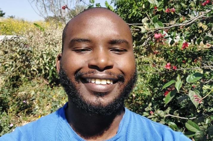 Rodgers Iradukunda headshot in front of greenery