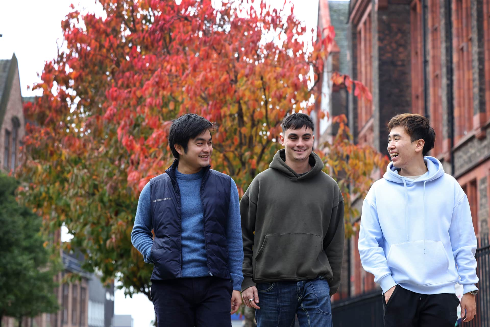 Three students walk through campus.