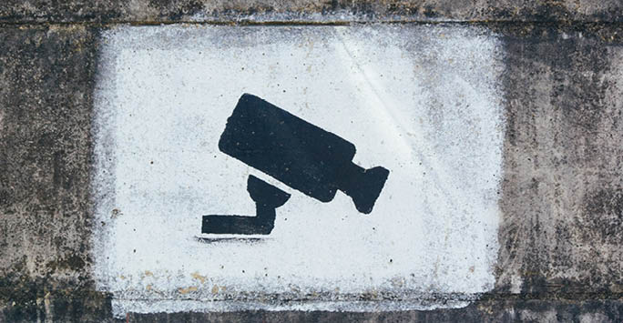 A spray painted camera on a wall