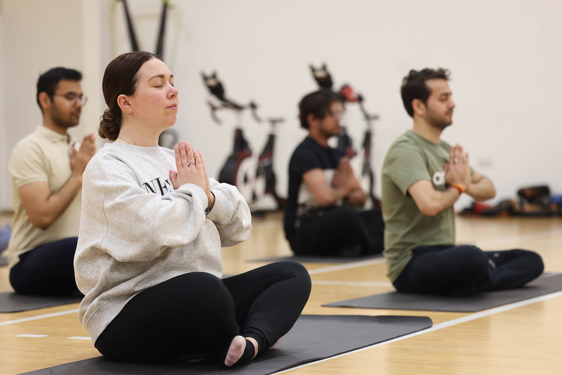 Group of people meditating in a fitness class