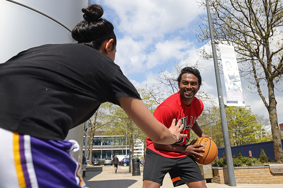 Students playing basketball outside