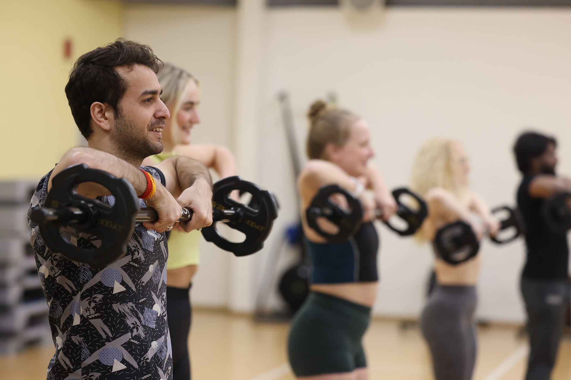 Group of people using dumbells to exercise