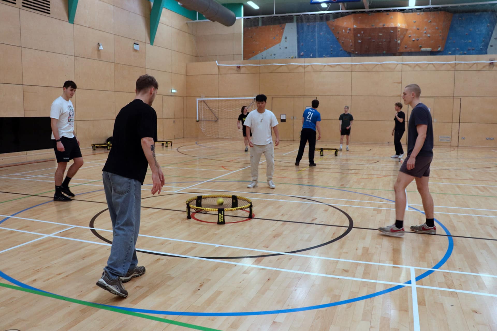 Staff playing sport in the sports centre hall