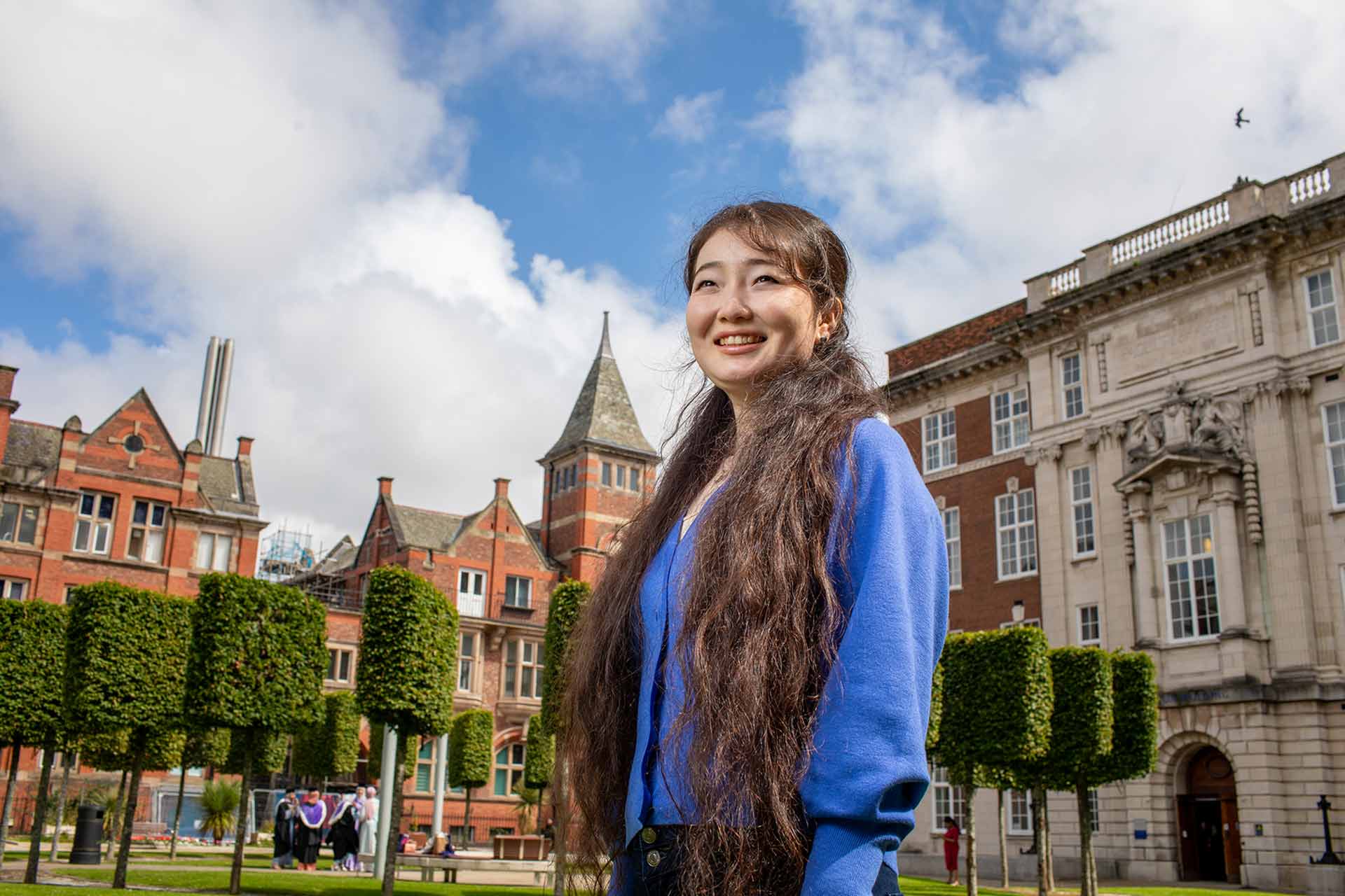 Portrait of a smiling student in the quadrangle area of the University of Liverpool campus