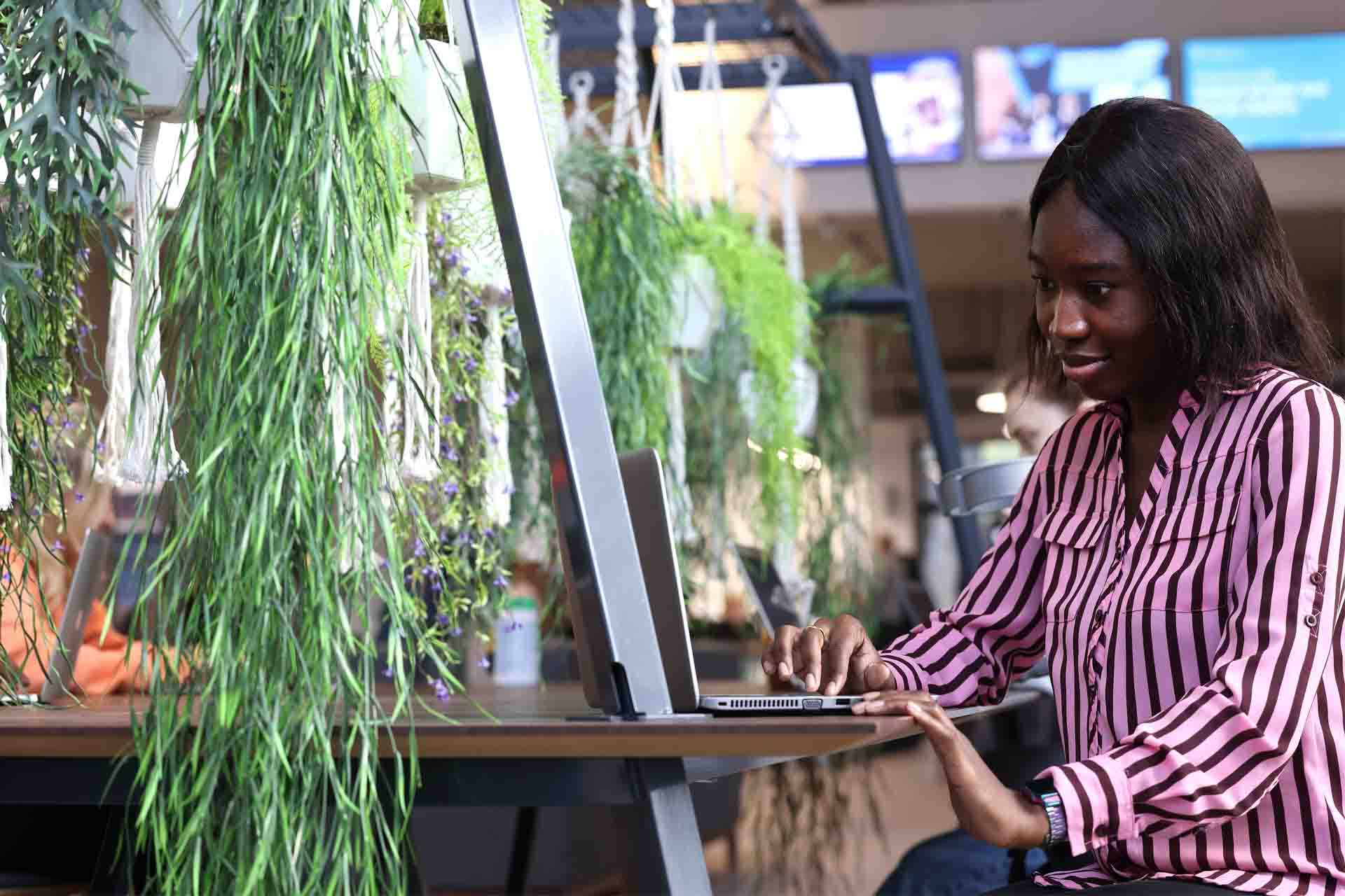 A student is working on a laptop at a desk.