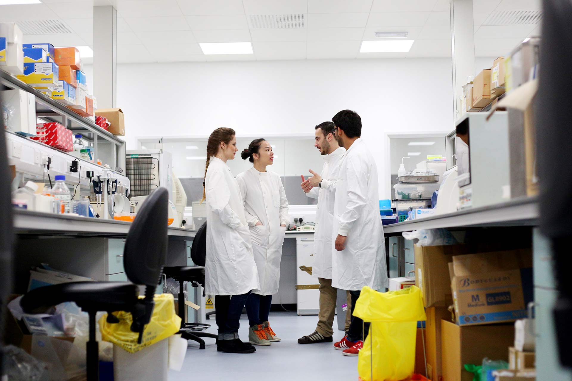 Four postgraduate research students in a laboratory