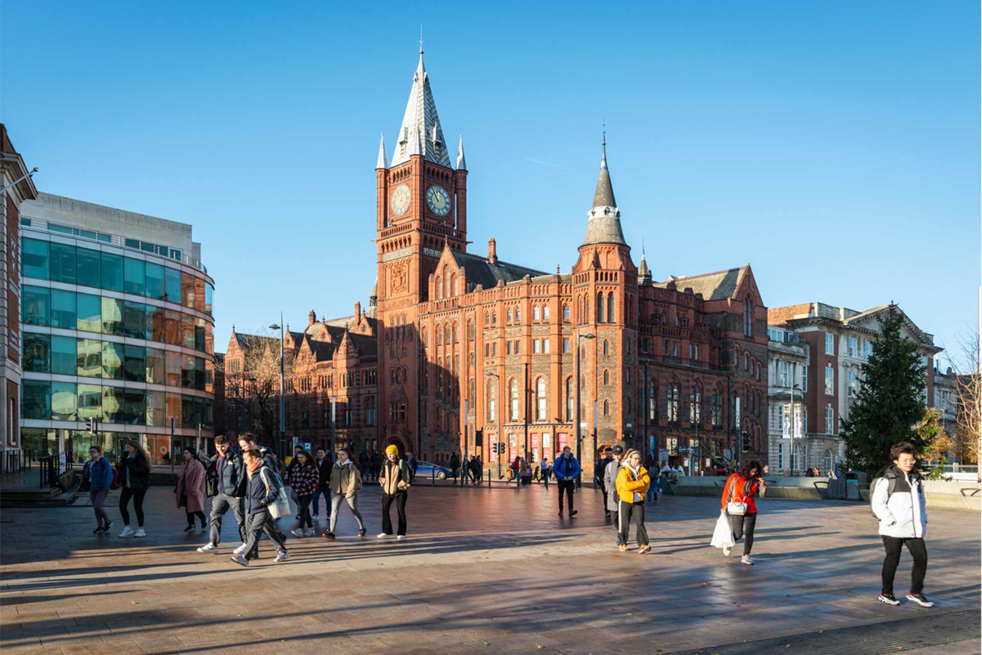 Students walking across campus with a view of the Victoria Gallery & Museum in the background