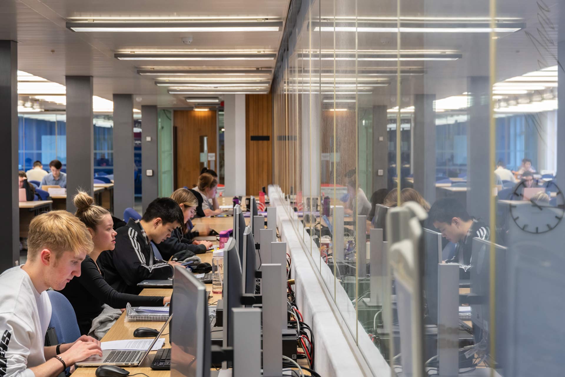 Students using the computers to study in Sydney Jones Library