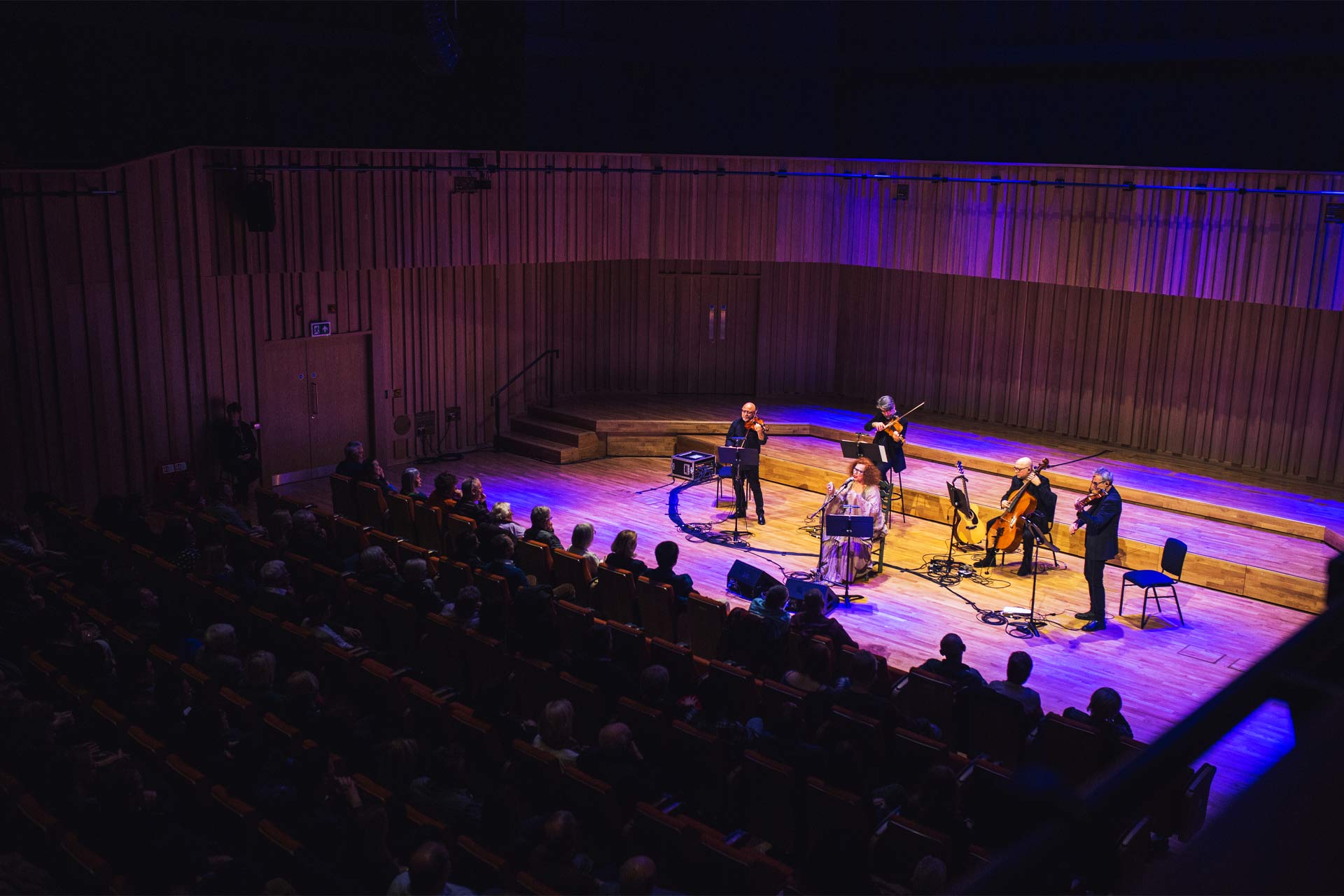 An orchestra performing at the Tung Auditorium