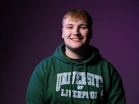 Image of a white male student smiling