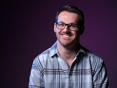 Image of a white male student smiling