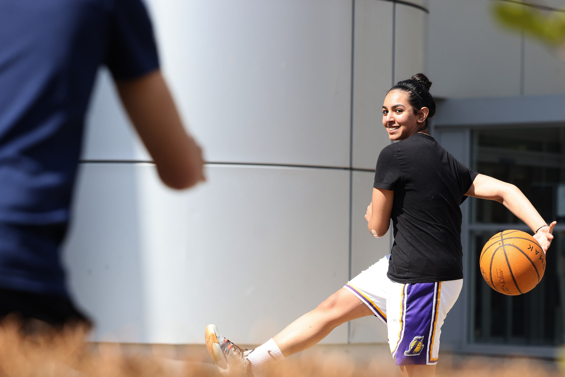 A woman playing with a basketball.