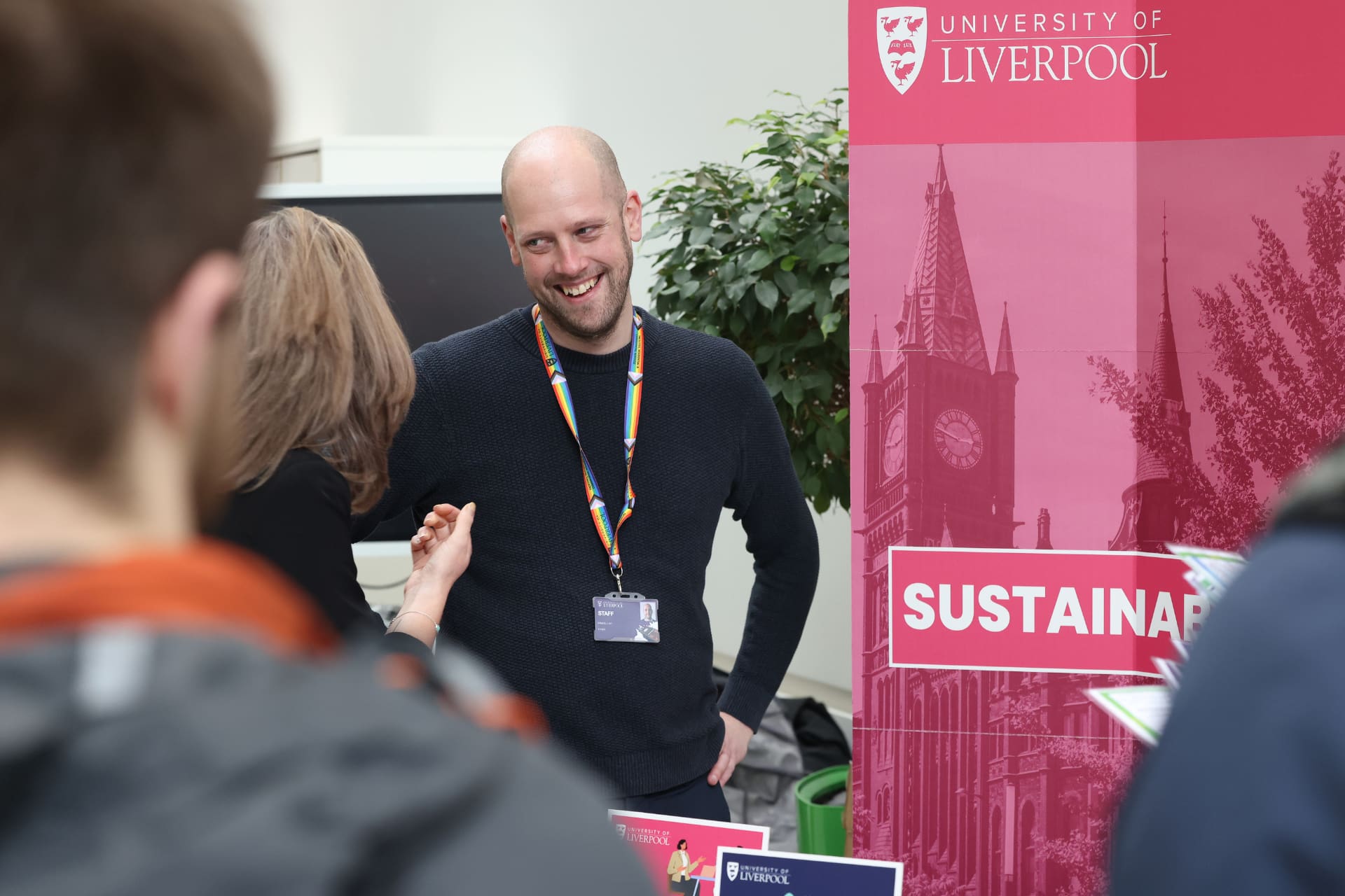 An employee of the sustainability team talking with staff and students.