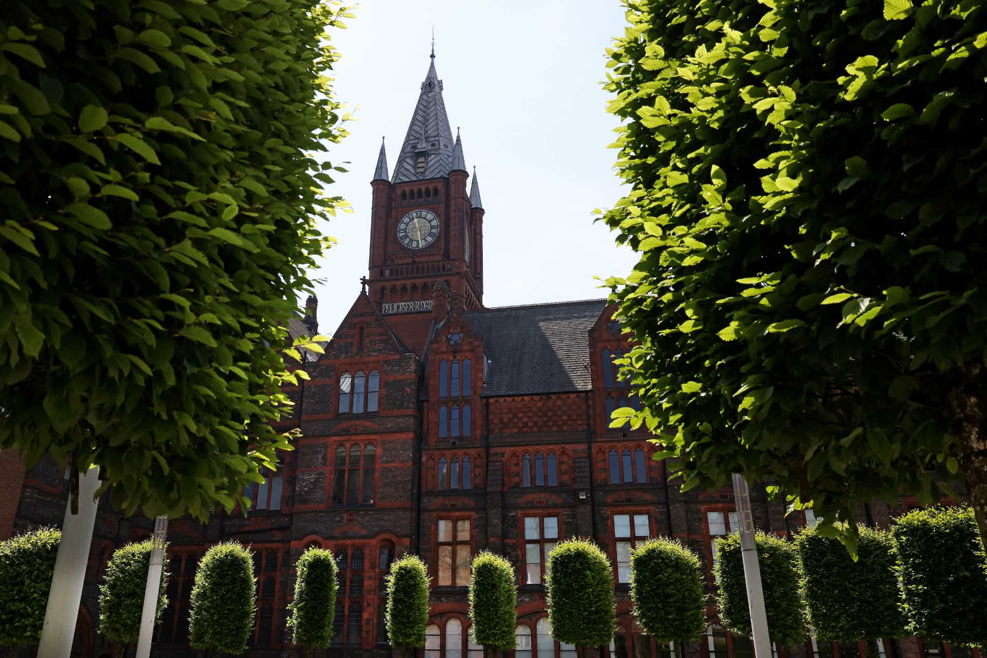 The Victoria Building behind trees and bushes