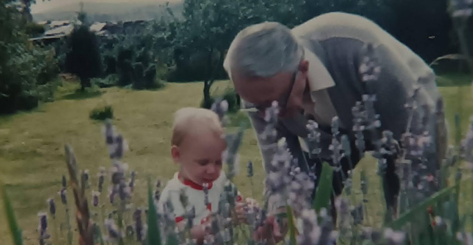 Elinor as a toddler in the garden with her grandfather