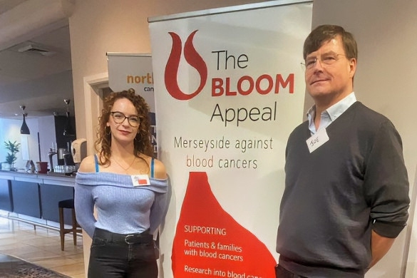 Abigail Clark and Professor Joe Slupski stood next to The Bloom Appeal banner